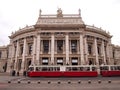Vienna, Austria - September 26, 2014: Historic Burgtheater (Court Theatre) at the famous Wiener Ringstrasse with people and the tr Royalty Free Stock Photo