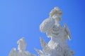 Imposing white marble sculpture of soldier above against clear blue sky