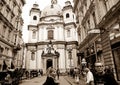 People surrounded by traditional European architecture with gree