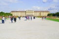 Tourists in front Baroque architectural Schonbrunn imperial palace, one of the major tourist attractions in Vienna, Austria