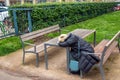 Tired woman sleeps sitting at a table in one of the parks in Vienna