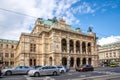 Wide three quarter view of tourists walking by the historic 1,709-seat Renaissance Revival Vienna