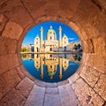 Vienna. Karlskirche church of Vienna reflection view through stone window