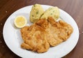 Vienna schnitzel with mashed potatoes and baby onion