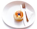 Viennese cake, with a blueberry on top, on a white background