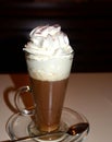 Viennese coffee with whipped cream on glass cup.