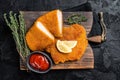 Viennese veal escalope, fried meat Schnitzel steak. Black background. Top view