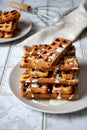 Viennese waffles with condensed milk on a light background