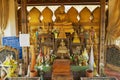 Buddha statues and altar in a small chapel next to the Pha That Luang stupa in Vientiane, Laos.
