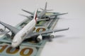 Airplane models on runway of 100 dollar paper money bills