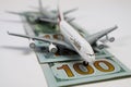 Airplane models on runway of 100 dollar paper money bills