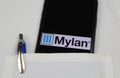 Close up of mobile phone screen with logo lettering of Mylan pharmaceutical company in pocket of white doctors coat with pencil