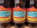 Closeup of bottels Kona hawaiian craft beer longboard in shelf of german supermarket