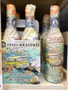 Closeup of collection craft beer bottles wrapped in artful vintage style paper from german local Insel-Brauerei in shelf