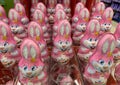 Closeup of many pink kinder chocolate easter bunnies in shelf of german supermarket