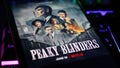 Netflix series Peaky Blinders cover poster on smartphone screen on computer keyboard Royalty Free Stock Photo