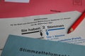 Closeup of german ballot paper for postal voting with red pencil and envelopes