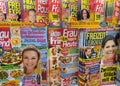 View on isolated kiosk shelf with variety of german yellow gossip press magazines