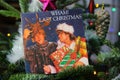 Close up of vintage vinyl record cover single with famous Wham last christmas song in decorated fir tree