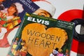 Close up of vintage vinyl record cover singles with famous christmas songs focus on Elvis Presley wooden heart cover