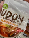 Closeup of japanese udon instant seafood noodles in front of shelf of german supermarket