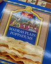 Closeup of pack truly indian plain madras poppadums in front of shelf of german supermarket Royalty Free Stock Photo