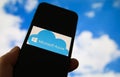 Closeup of smartphone with logo lettering of cloud computing provider service microsoft azure, blurred sky and cloud background