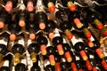 Collection of dusty red wine bottles in a shelf in a row Royalty Free Stock Photo