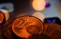 Macro close up of pile one and two euro cent copper coins on computer screen