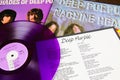 Close up of Deep Purple band album covers with retro purple colored vinyl record