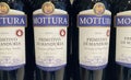 Closeup of bottles italian Mottura Primitivo di Manduria red wine in shelf of german store Royalty Free Stock Photo