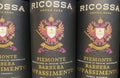 Closeup of bottles italian Ricossa Piemonte Barbera Appassimento red wine in shelf of german store