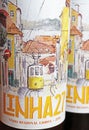 Closeup of portuguese Linha 27 red country wine bottle label with drawing of lisbon cable tram