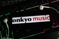 Closeup of smartphone screen with logo lettering online music download service onkyo on computer keyboard