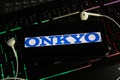 Closeup of smartphone screen with logo lettering online music download service onkyo on computer keyboard