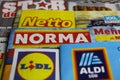 Macro closeup of weekly printed advertising inserts from german discounter companies lidl, aldi, norma, netto