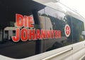 View on window of patient transport ambulance van with lettering of german voluntary humanitarian organisation Die Johanniter