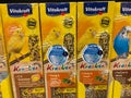 Closeup of carton boxes with vitakraft bird food in shelf of german supermarket