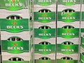 Closeup of green grey stack Becks beer crates in german store