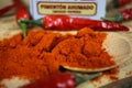 Closeup of over pile red smoked paprika powder seasoning and chillies on spice can Royalty Free Stock Photo