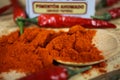 Closeup of over pile red smoked paprika powder seasoning and chillies on spice can Royalty Free Stock Photo