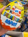 View on kinder surprise egg hold by hand in german supermarket