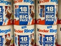 View on stack Kinder Riegel chocolate bar boxes in shelf of german supermarket