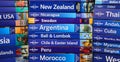 View on stack of lonely planet trevel guide books from all over the world focus on center