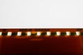 Close up of isolated old filmstrip, white background focus on word Kodak