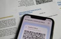 Viersen, Germany - June 24. 2021: Closeup of mobile phone screen with barcode of digital covid-19 vaccination certificate covpass