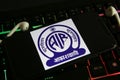 Closeup of mobile phone screen with logo lettering of air all india radio station on computer keyboard