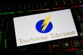 Closeup of mobile phone screen with logo lettering of film production company touchstone television on computer keyboard Royalty Free Stock Photo