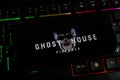 Closeup of mobile phone screen with logo lettering of film production ghost house pictures company on computer keyboard