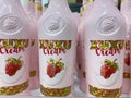 Closeup of pink bottles with xuxu cream strawberry liqueur in shelf of german supermarket